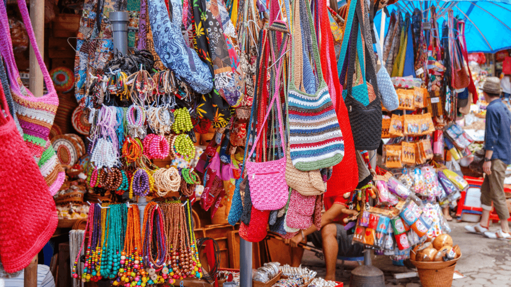 Colorful handmade bags, jewelry, and souvenirs at a vibrant local market in Seminyak, Bali – perfect for shopping unique Balinese crafts.