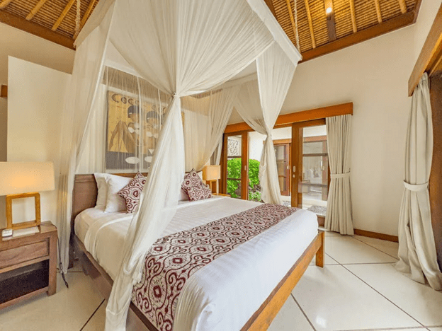 Comfortable bedroom at Villa Darma Seminyak with pool view, ideal for family stays in Seminyak Villas Bali