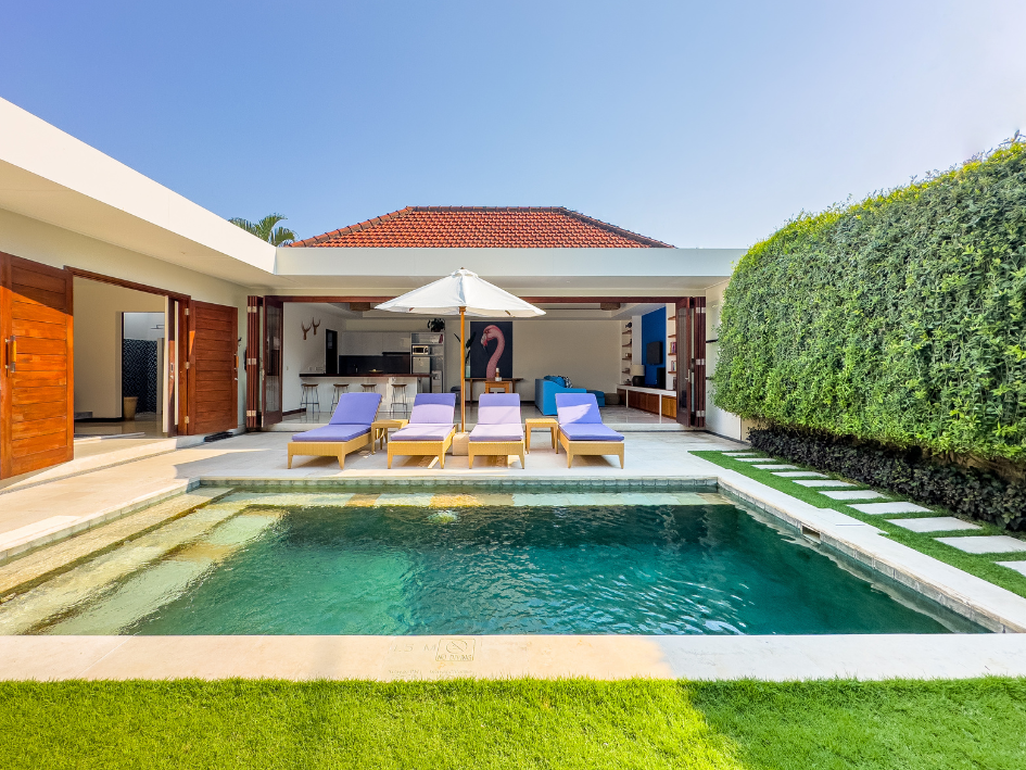 Sunbeds beside the private pool at a Seminyak villa in the afternoon