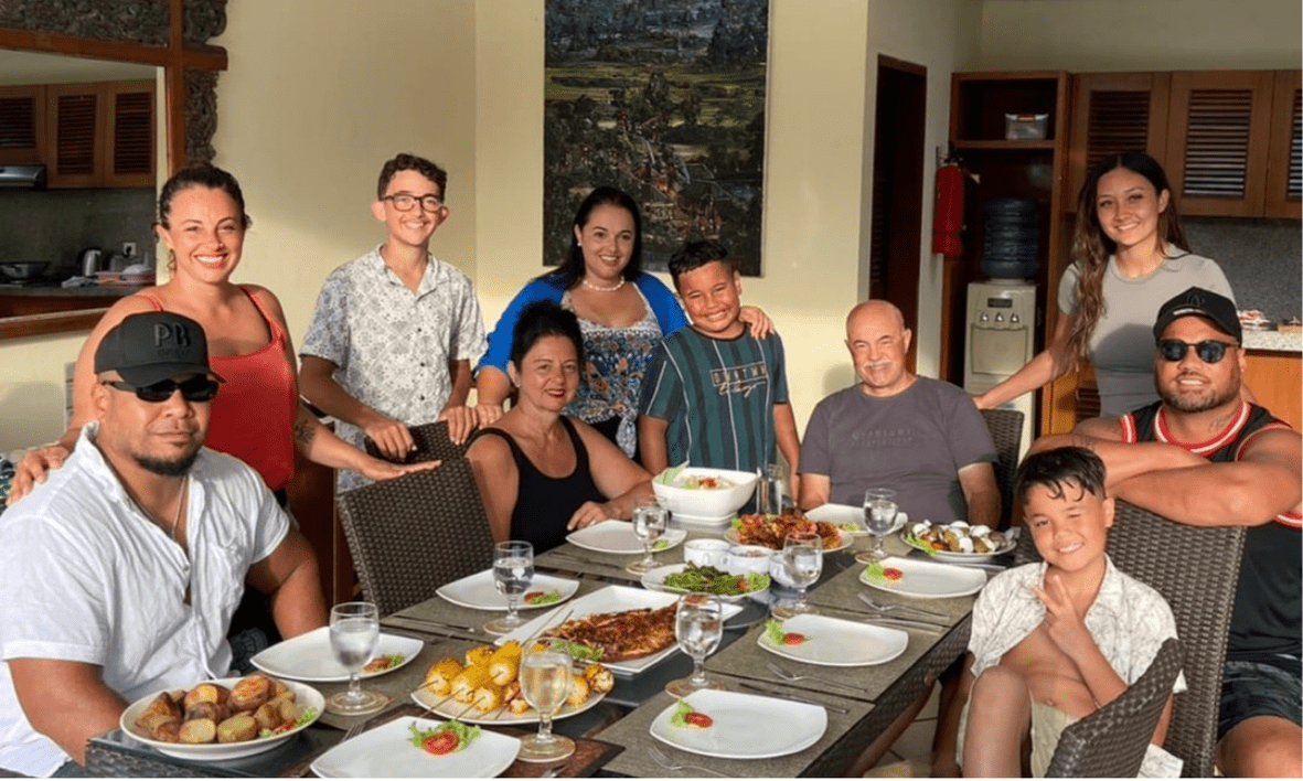 Multi-generational family gathered around the private pool at a Villa Bugis villa