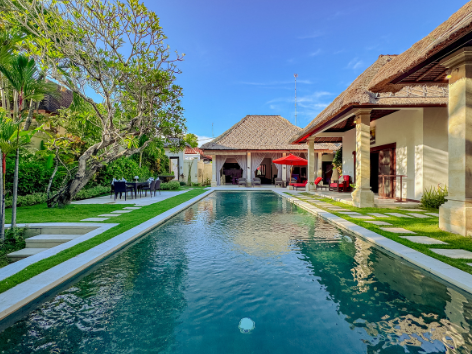 View across the private pool toward the open-air living pavilion at a Villa Bugis villa