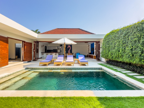 Private infinity pool surrounded by tropical landscaping at a Villa Bugis villa in Seminyak