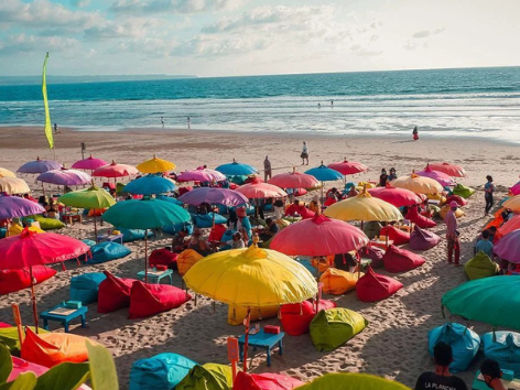 Colourful beach umbrellas and sunbeds on Seminyak Beach Bali