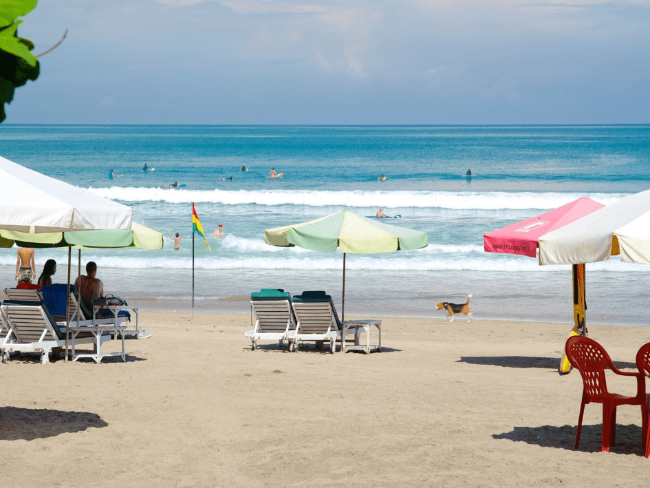 Surfer riding a morning wave at Seminyak Beach