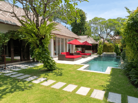 Lush tropical garden and palm trees at a Villa Bugis private villa in Seminyak Bali