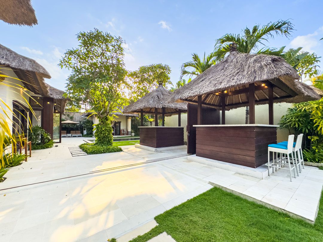 Beautiful pool deck and manicured garden area at Villa Alore Seminyak by Villa Bugis Seminyak villas, ideal for large group vacations.