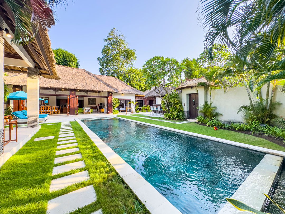 Serene poolside relaxation zone featuring traditional Balinese garden elements at Villa Alore Seminyak by Villa Bugis Seminyak villas.