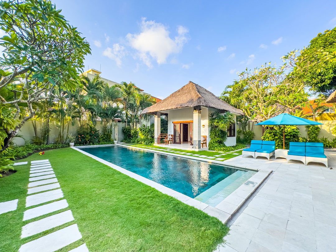 Sunny daytime landscape view of the poolside lounge area at Villa Alore Seminyak by Villa Bugis Seminyak villas.