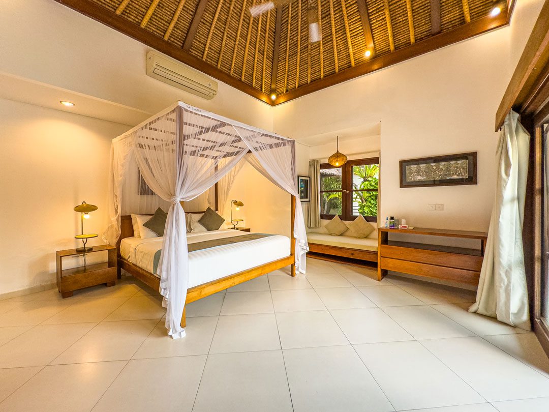Spacious interior design of king bedroom 1 at Villa Alore Seminyak by Villa Bugis Seminyak villas, complete with air conditioning and elegant decor.