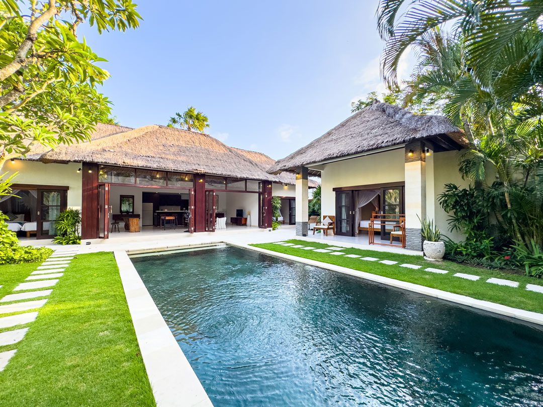 Expansive private outdoor swimming pool at Villa Alore Seminyak by Villa Bugis, a luxury 6-bedroom villa Seminyak with sun loungers and tropical gardens.
