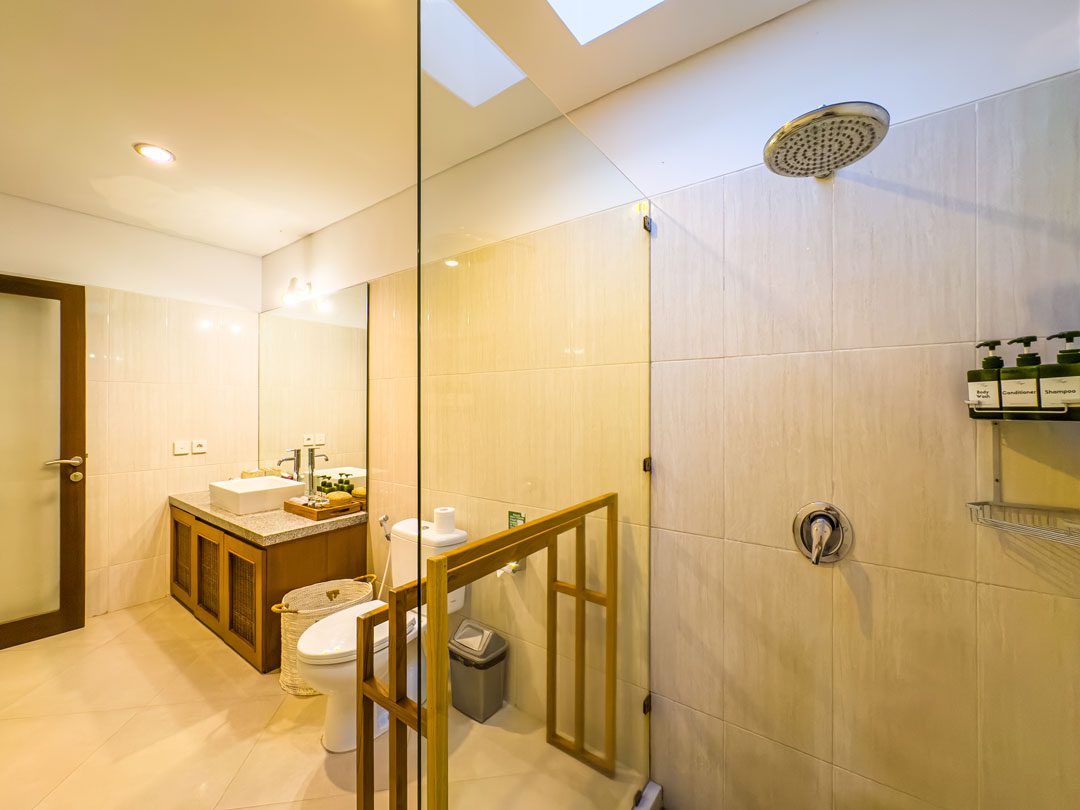 Modern stone sink and clean amenities in the private bathroom of bedroom 5 at Villa Alore Seminyak by Villa Bugis Seminyak villas.