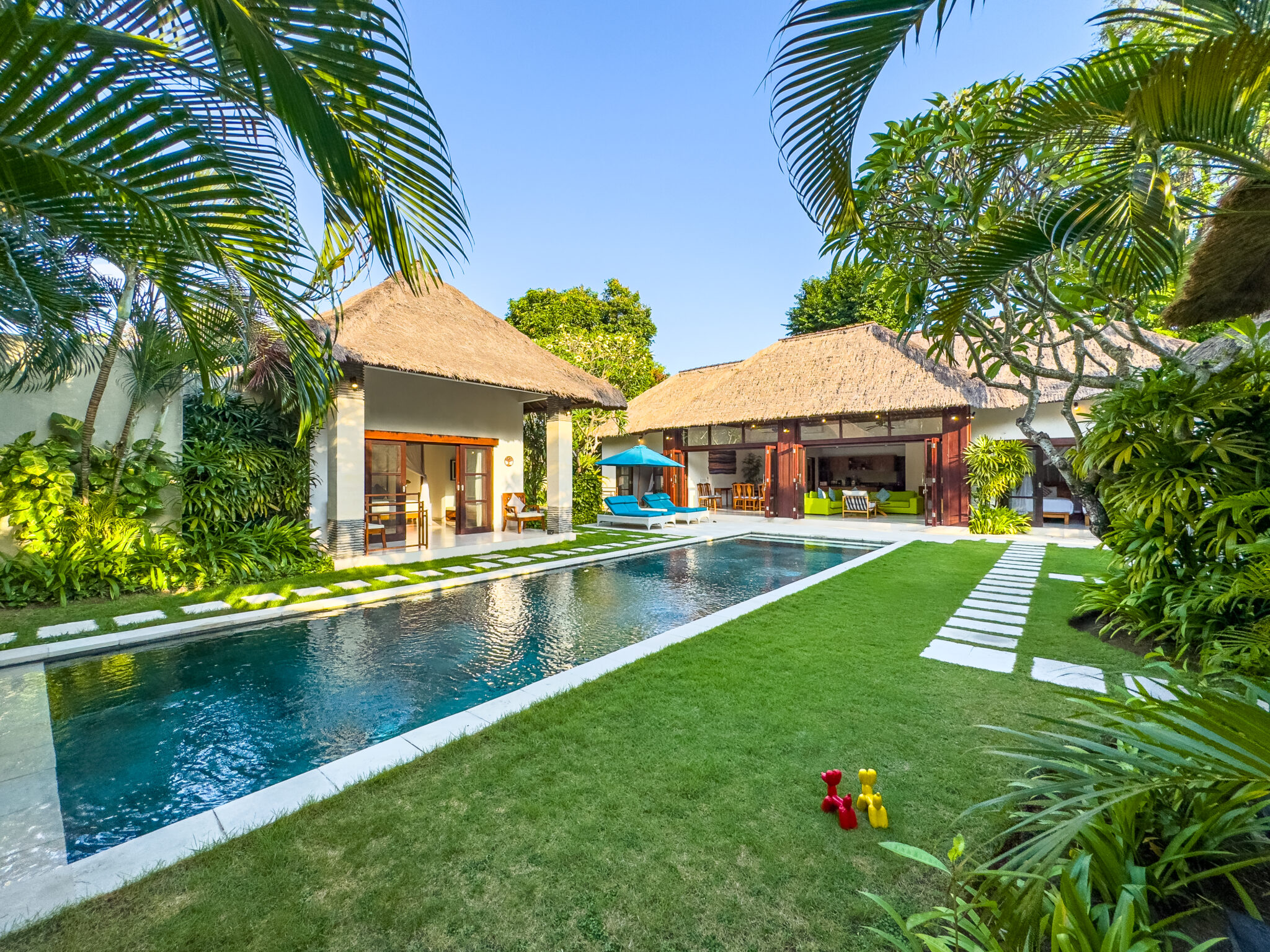 Private swimming pool and sun loungers in the tropical garden at Villa Alore Seminyak