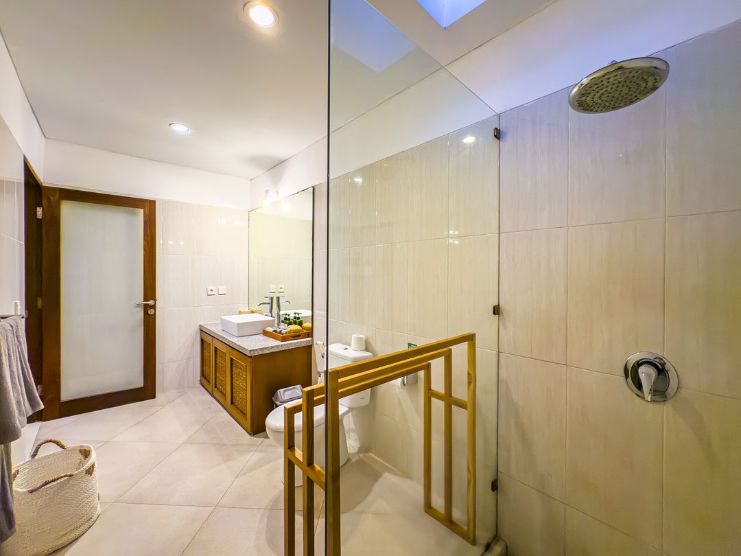 Clean vanity mirror and spacious shower area in the bathroom of bedroom 3 at Villa Alore Seminyak by Villa Bugis Seminyak villas.
