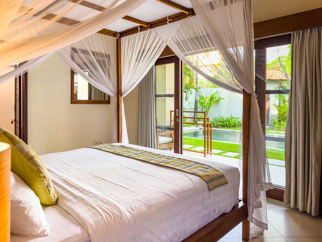 Tastefully decorated king bedroom 6 at Villa Alore Seminyak by Villa Bugis villa Seminyak, featuring premium bedding and private pool views.