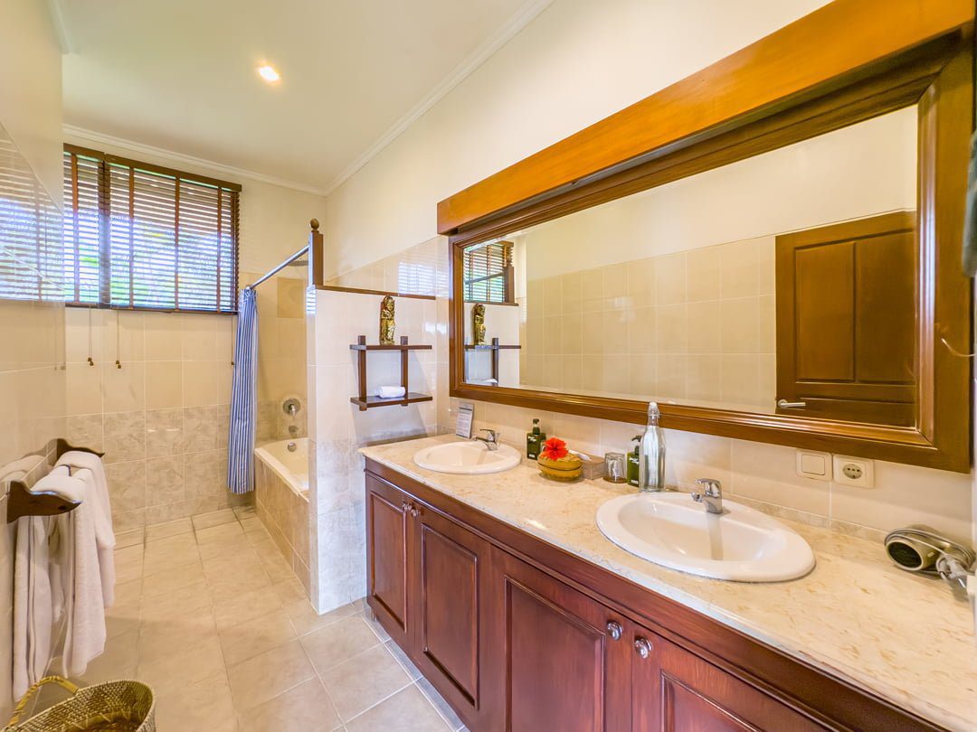 Ensuite luxury bathroom in the master suite at Villa Arjuna Seminyak by Villa Bugis, featuring a beautiful semi-open tropical design villa Seminyak.
