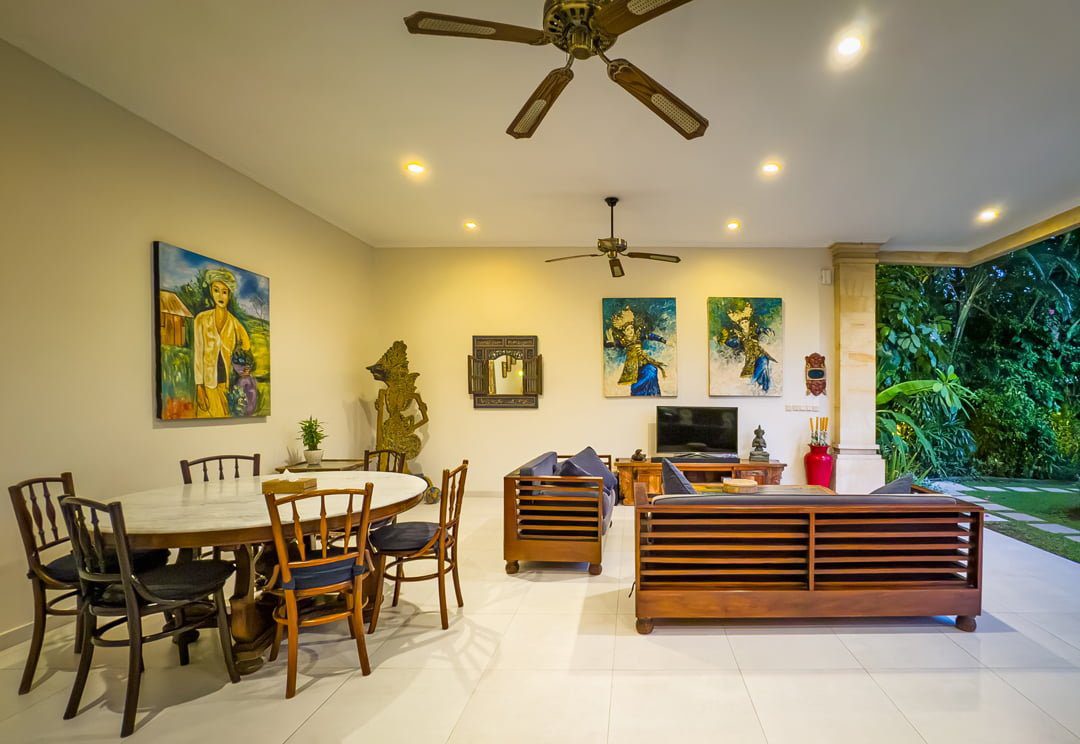 Spacious open-plan living room with comfortable plush sofas facing the private pool at Villa Arjuna Seminyak by Villa Bugis villa Seminyak.