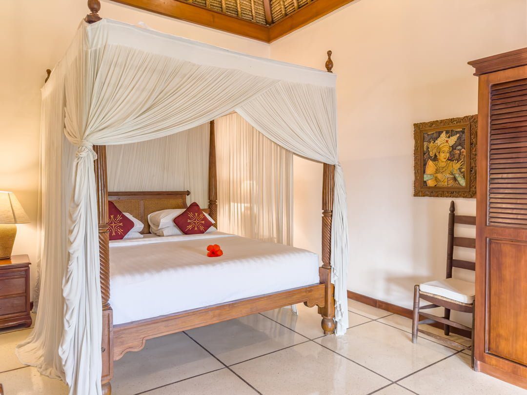 Interior layout of bedroom 1 at Villa Arjuna Seminyak by Villa Bugis Seminyak villas, featuring cozy tropical decor, air conditioning, and elegant furnishings.
