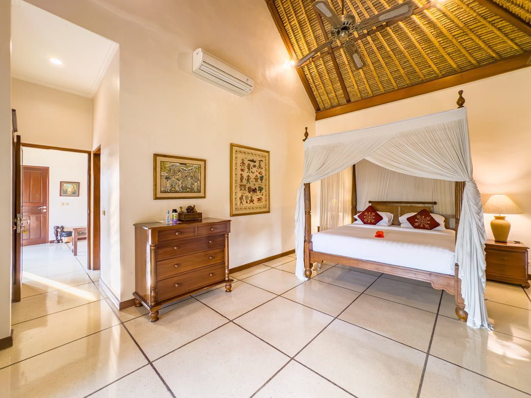 Elegant master bedroom with a premium king-size bed setup at Villa Arjuna Seminyak by Villa Bugis, a top-rated villa Seminyak for a relaxing holiday.