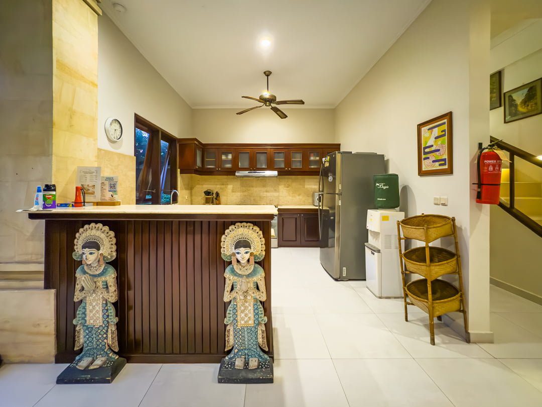 Clean fully-fitted kitchen and minimalist dining area at Villa Arjuna Seminyak by Villa Bugis, offering home-style convenience in Seminyak villas.
