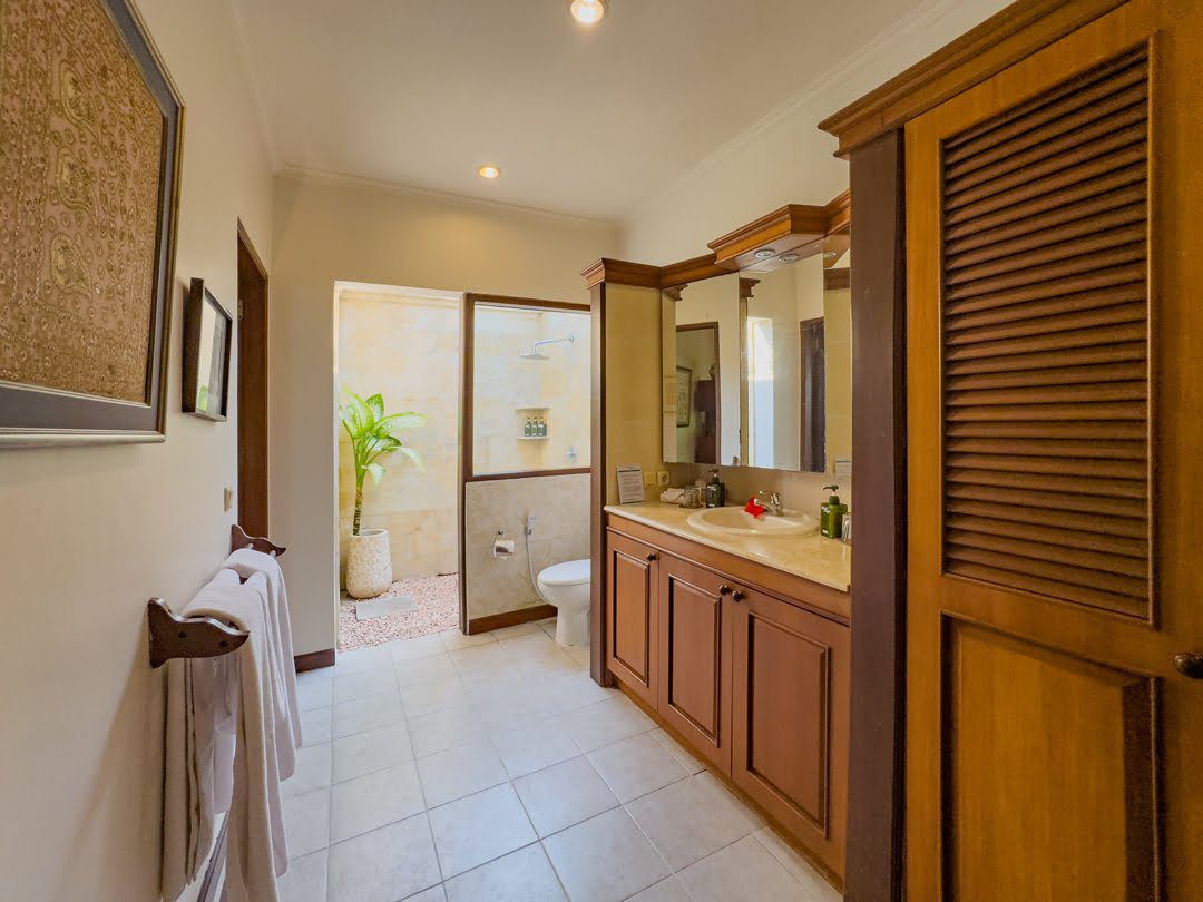 Semi-outdoor private bathroom attached to bedroom 2 at Villa Arjuna Seminyak by Villa Bugis, offering a unique and refreshing villa Seminyak experience.