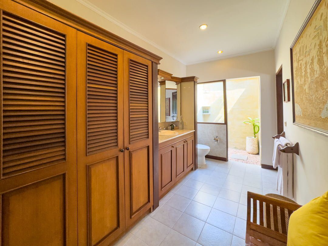 Elegant stone design and minimalist vanity inside the open-air bathroom of bedroom 3 at Villa Arjuna Seminyak by Villa Bugis Seminyak villas.