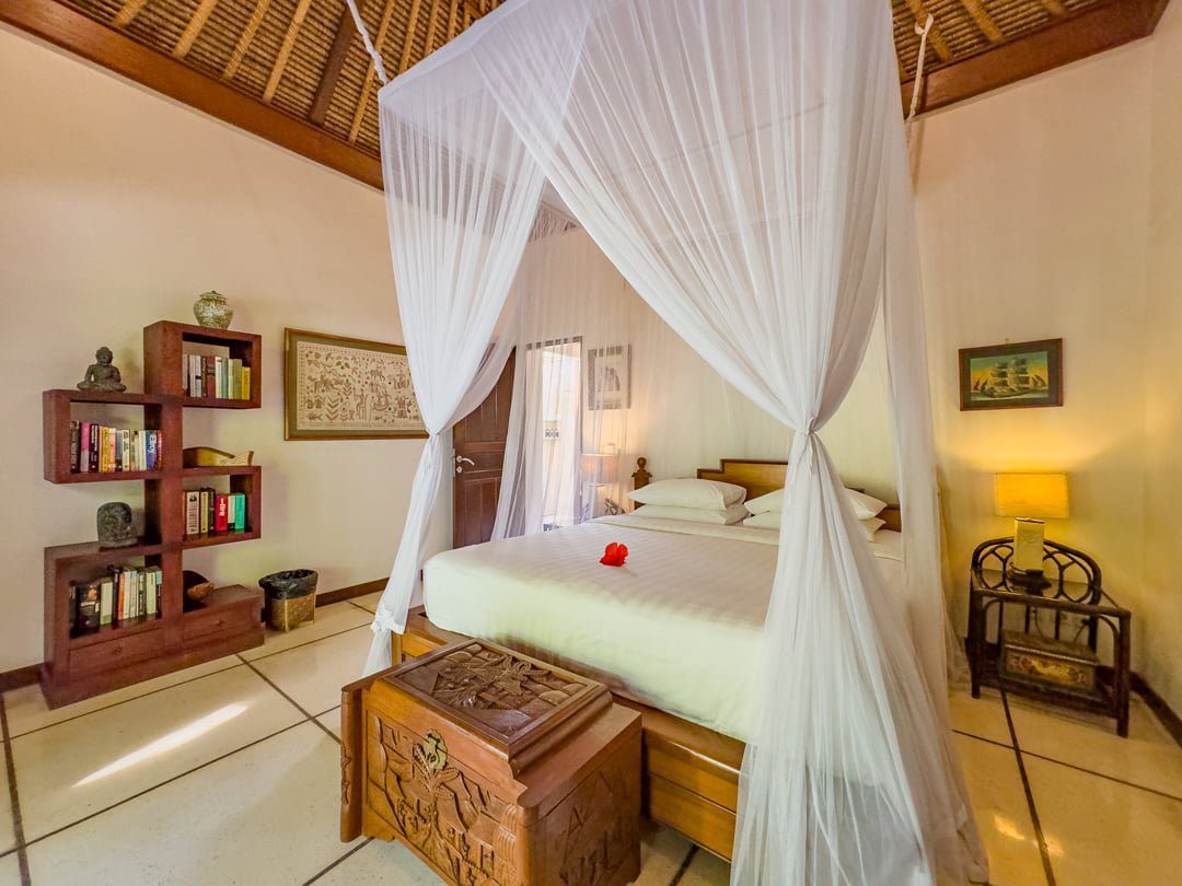 Cozy second bedroom at Villa Arjuna Seminyak by Villa Bugis villa Seminyak, displaying beautiful Balinese interior accents and fully-equipped amenities.