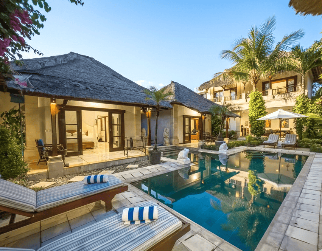 Sunny daytime view of the private pool side with traditional Balinese architectural details at Villa Arjuna Seminyak by Villa Bugis Seminyak villas.