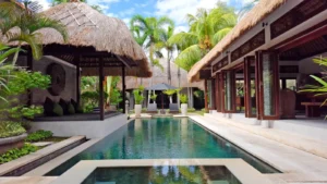 Long private pool between thatched Balinese pavilions at Villa Damai Seminyak, Bali