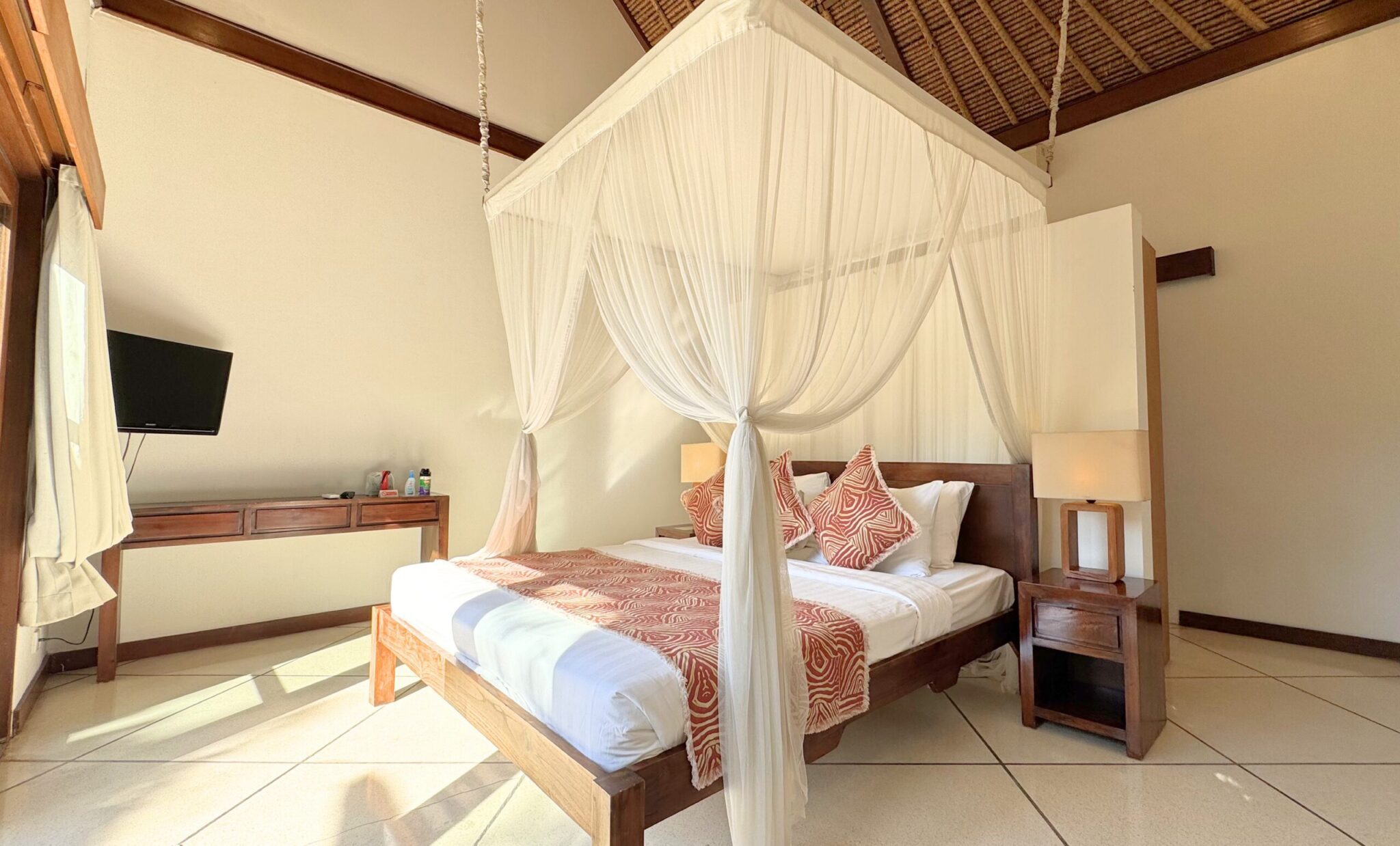 The fifth bedroom at Villa Darma Seminyak by Villa Bugis villa Seminyak, showcasing cozy bedding and tropical-themed interior details.