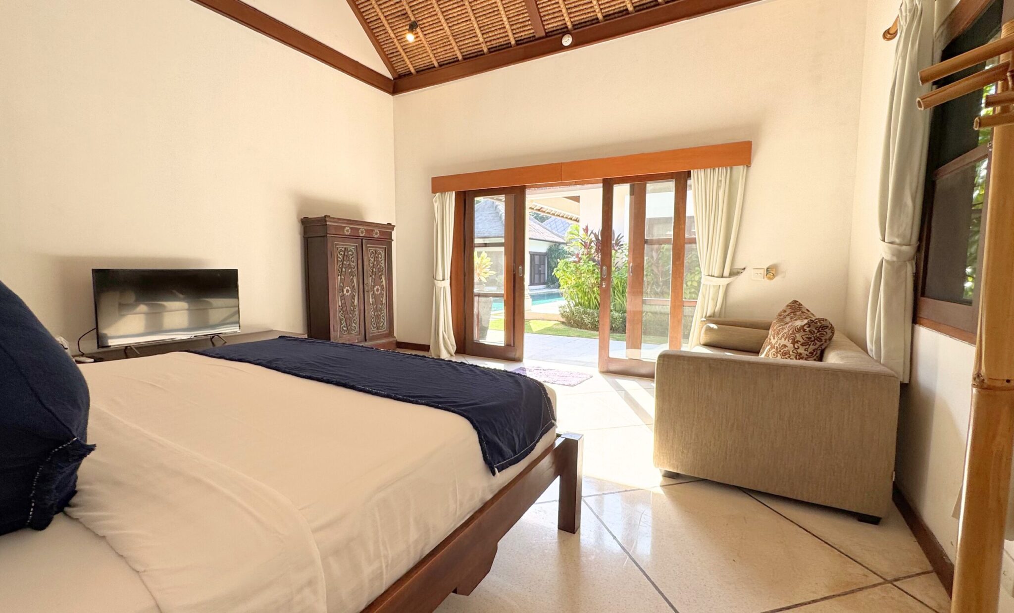 Neatly arranged king bed setup with pool views in bedroom 4 at Villa Darma Seminyak by Villa Bugis, ideal for groups looking for strategic Seminyak villas.