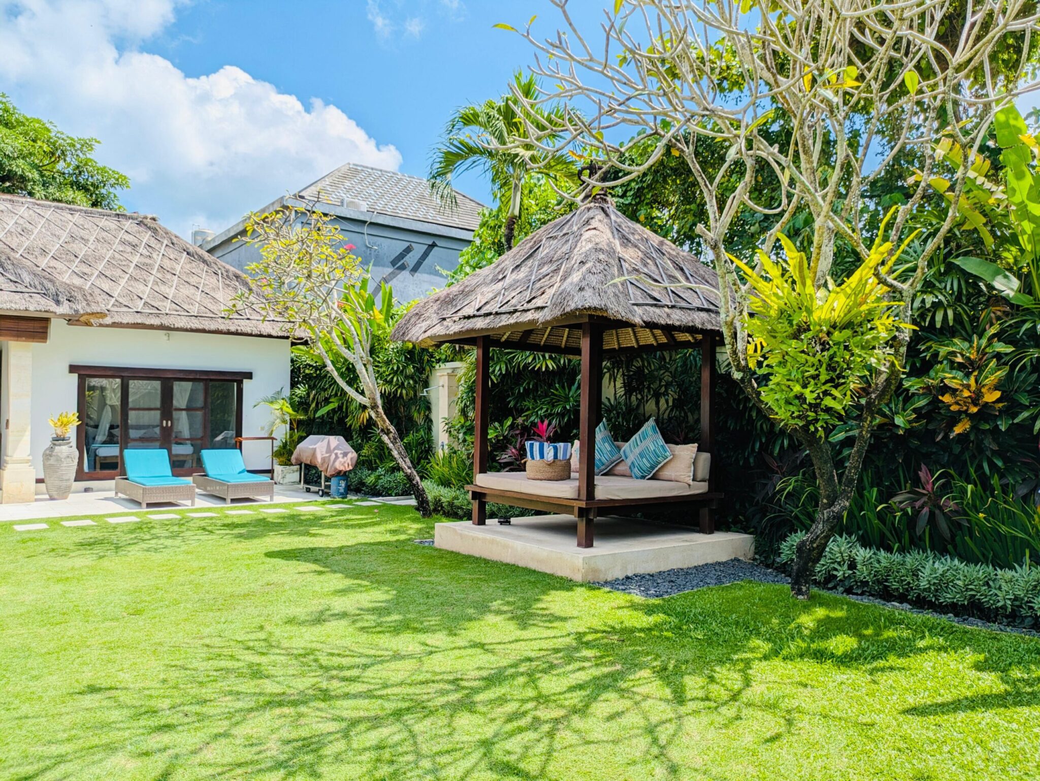 Tropical gazebo daybed surrounded by a lush garden at Villa Darma Seminyak by Villa Bugis villa Seminyak.