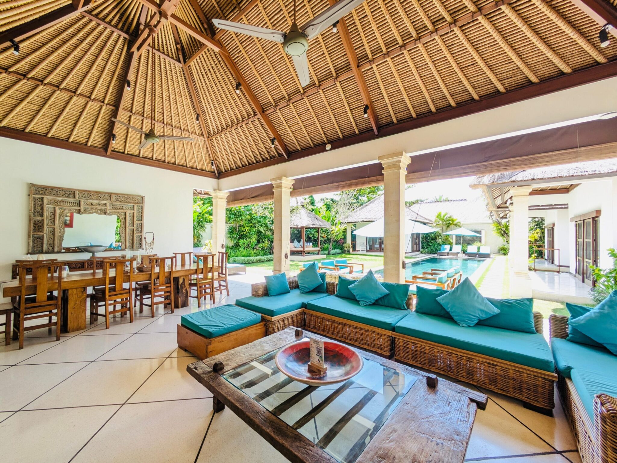 Spacious open-air living room with comfortable sofas facing the private pool at Villa Darma Seminyak by Villa Bugis villa Seminyak.