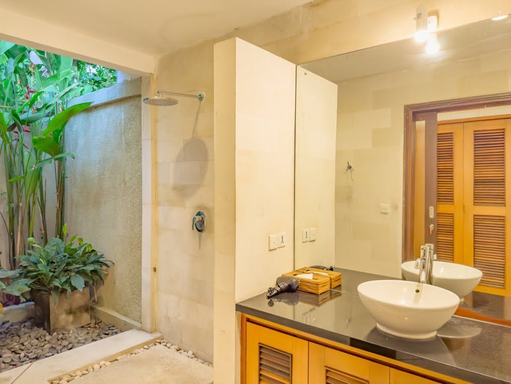 Spacious vanity area and clean modern amenities inside the master bathroom at Villa Darma Seminyak by Villa Bugis Seminyak villas.