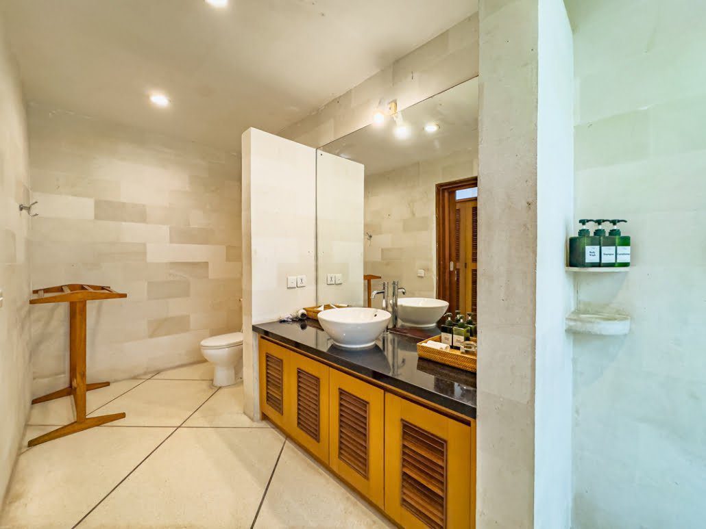 Clean shower area surrounded by tropical plants in the bathroom of bedroom 2 at Villa Darma Seminyak by Villa Bugis Seminyak villas.