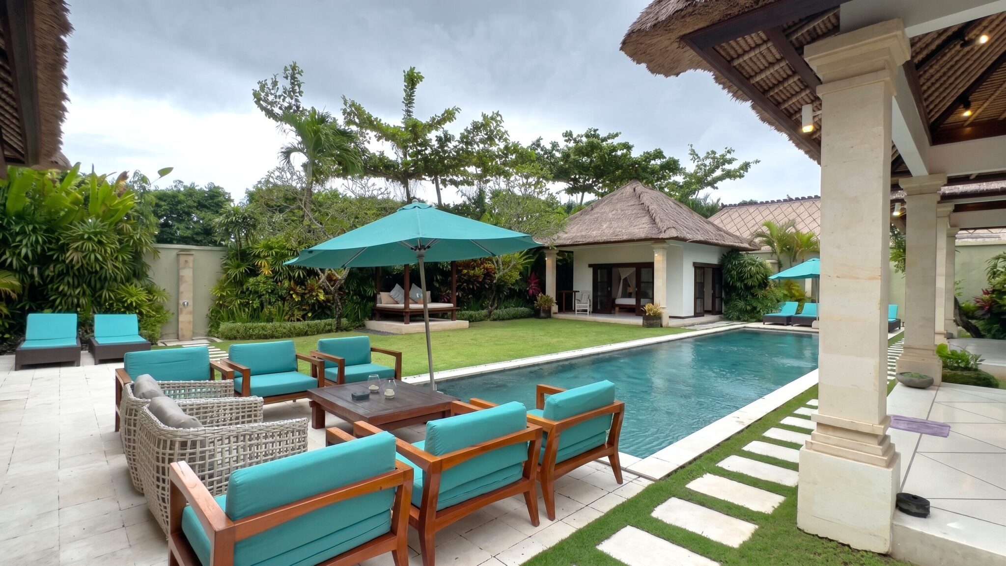 Sun-drenched private pool with tropical shade trees at Villa Darma Seminyak by Villa Bugis Seminyak villas.