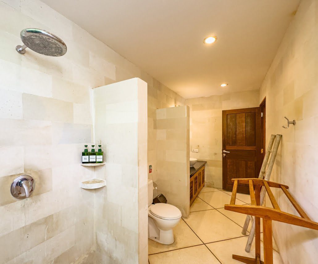 Elegant stone accents and minimalist design inside the bathroom of bedroom 3 at Villa Darma Seminyak by Villa Bugis Seminyak villas.