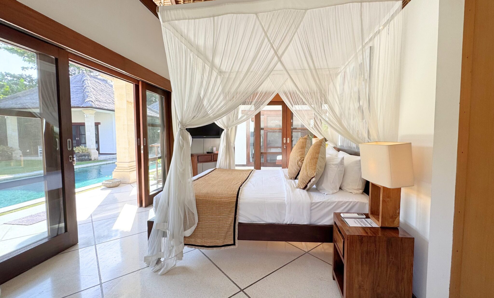 Serene third bedroom at Villa Darma Seminyak by Villa Bugis villa Seminyak with premium bedding and a beautiful view overlooking the pool.