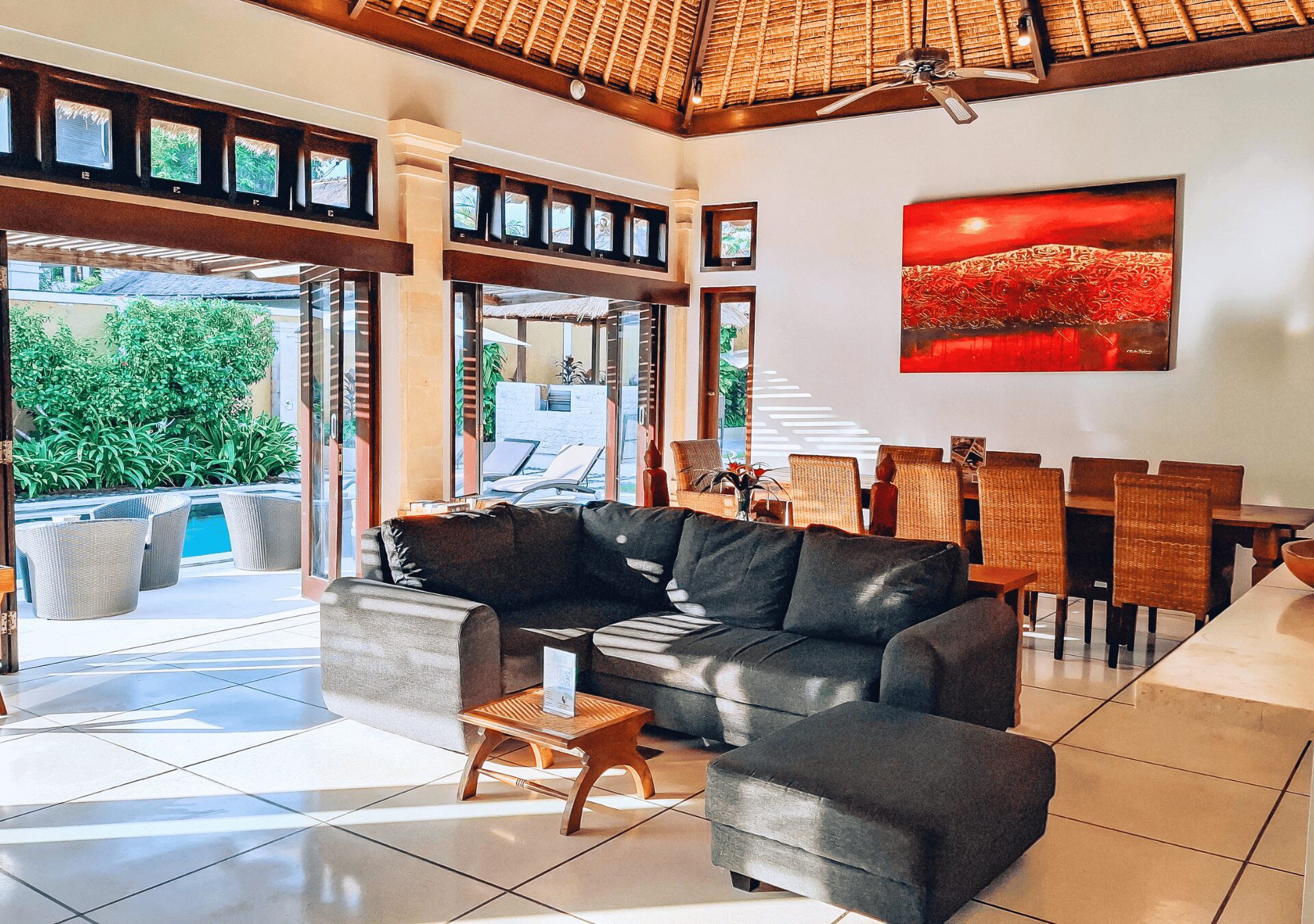 Tropical indoor-outdoor living concept overlooking the pool and garden at Villa Gembira Seminyak by Villa Bugis Seminyak villas.