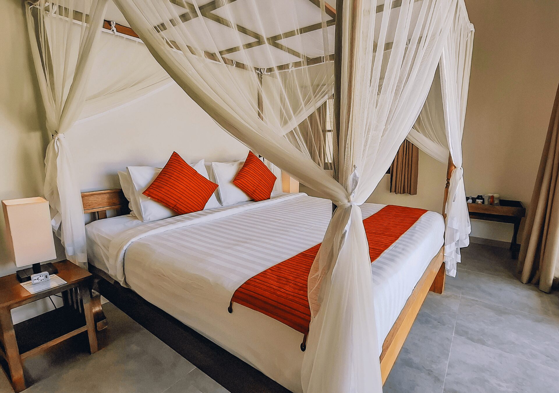Master bedroom featuring a luxurious king-size bed with tropical decor at Villa Gembira Seminyak by Villa Bugis, a top-rated villa Seminyak.