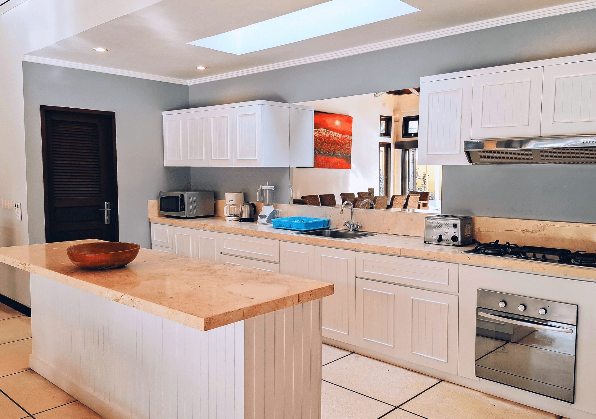 Modern open-concept kitchen fully equipped with high-quality appliances at Villa Gembira Seminyak by Villa Bugis villa Seminyak.