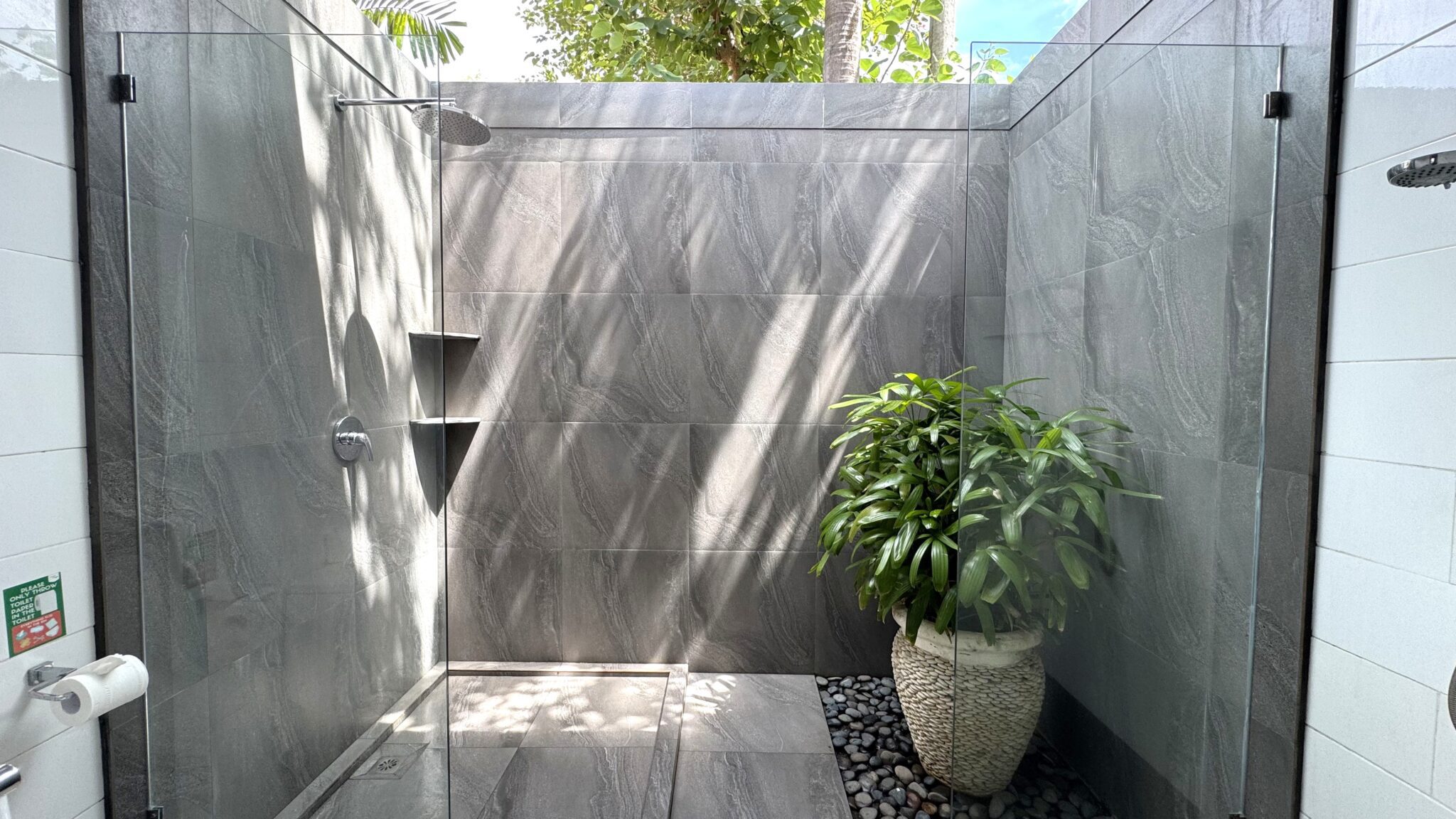 Elegant stone design and minimalist vanity inside the pristine bathroom of bedroom 3 at Villa Ginger Seminyak by Villa Bugis Seminyak villas.