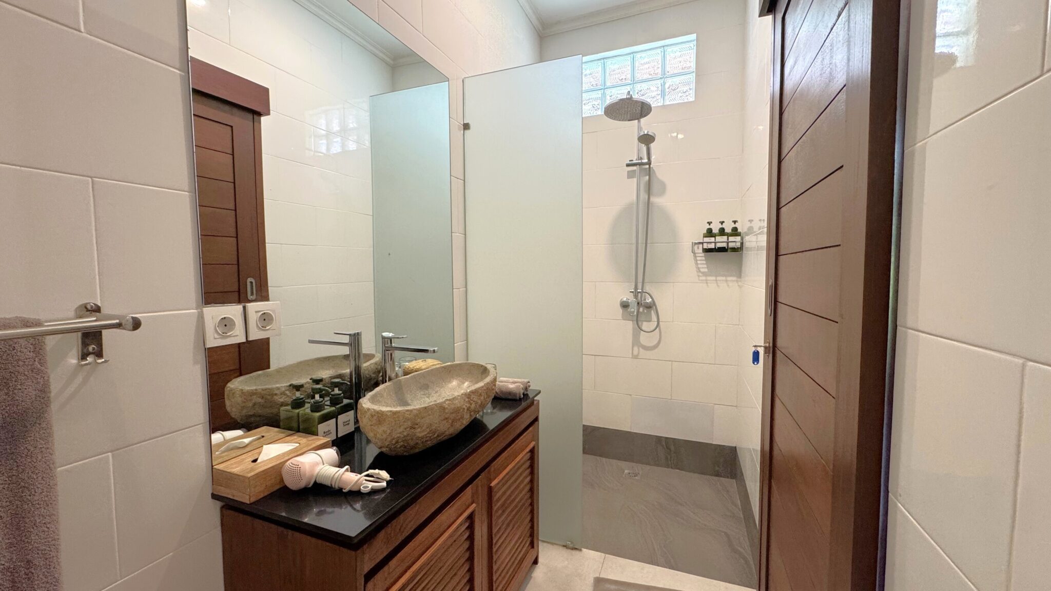 Well-lit vanity mirror and clean shower facilities inside the bathroom of bedroom 4 at Villa Ginger Seminyak by Villa Bugis Seminyak villas.