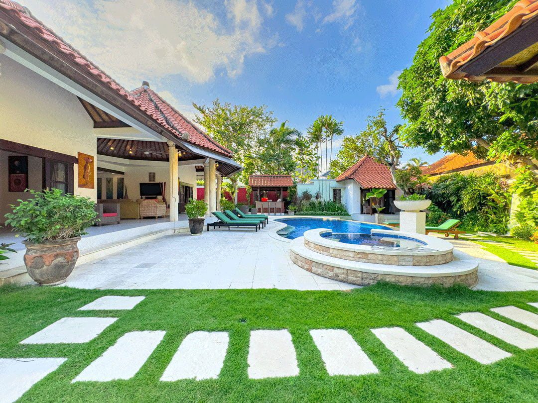 Private outdoor swimming pool at Villa Ginger Seminyak by Villa Bugis, a luxury villa Seminyak featuring comfortable sun loungers and a tropical garden.