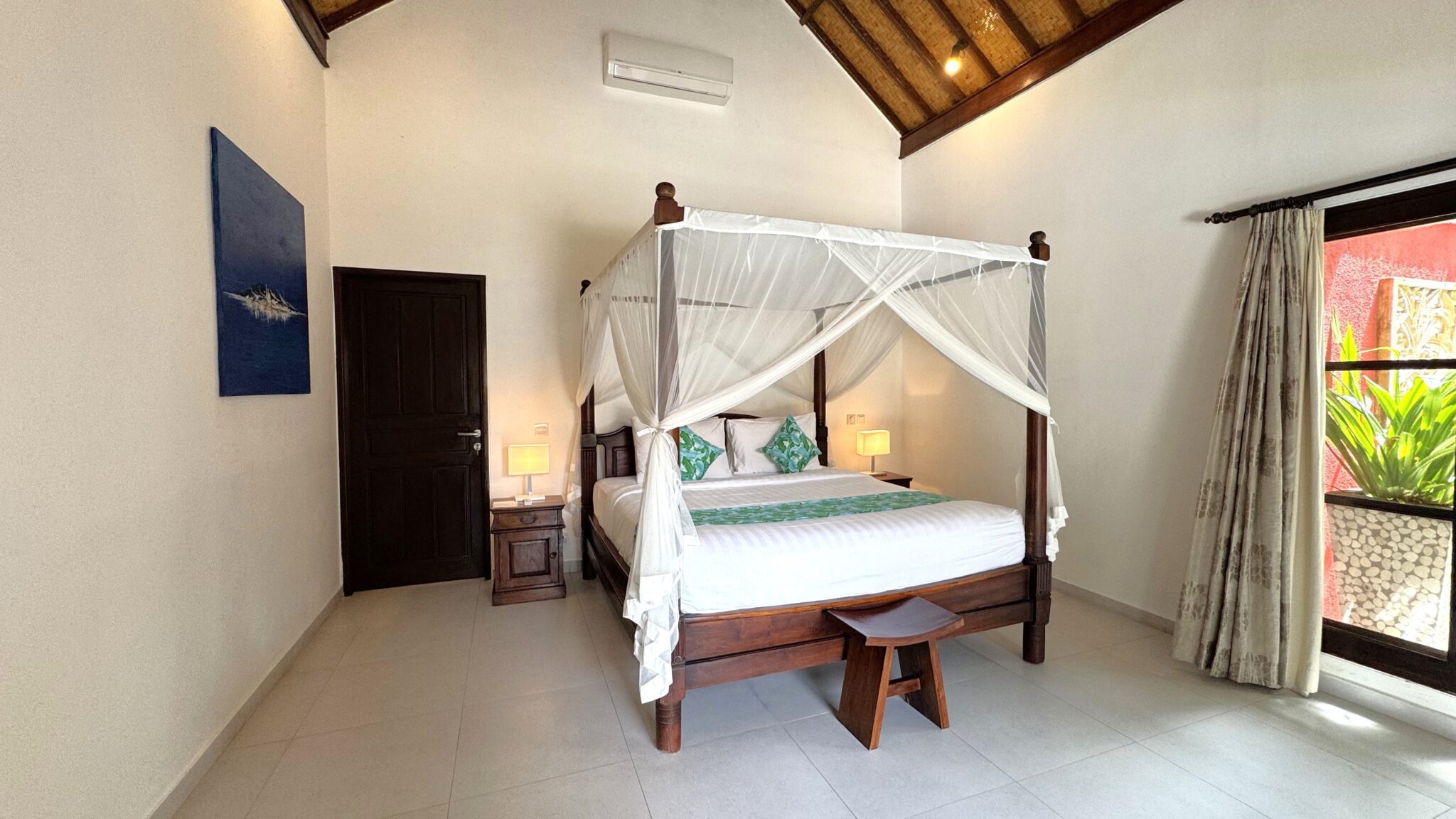 Interior layout of bedroom 1 at Villa Ginger Seminyak by Villa Bugis Seminyak villas, featuring cozy tropical decor, air conditioning, and elegant furnishings.
