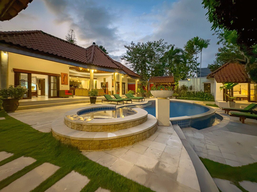 Serene evening ambiance with pool lights reflecting on the swimming pool at Villa Ginger Seminyak by Villa Bugis Seminyak villas.