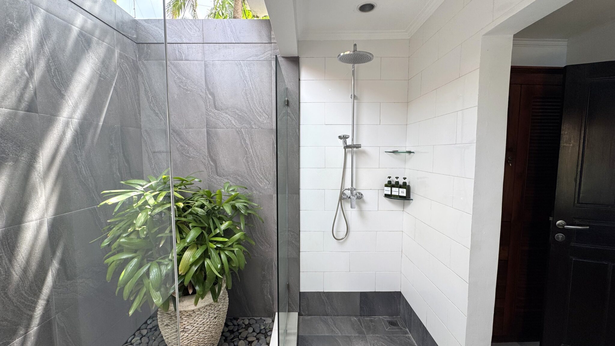 Ensuite tropical bathroom for bedroom 3 at Villa Ginger Seminyak by Villa Bugis, equipped with a modern refreshing shower in this villa Seminyak.