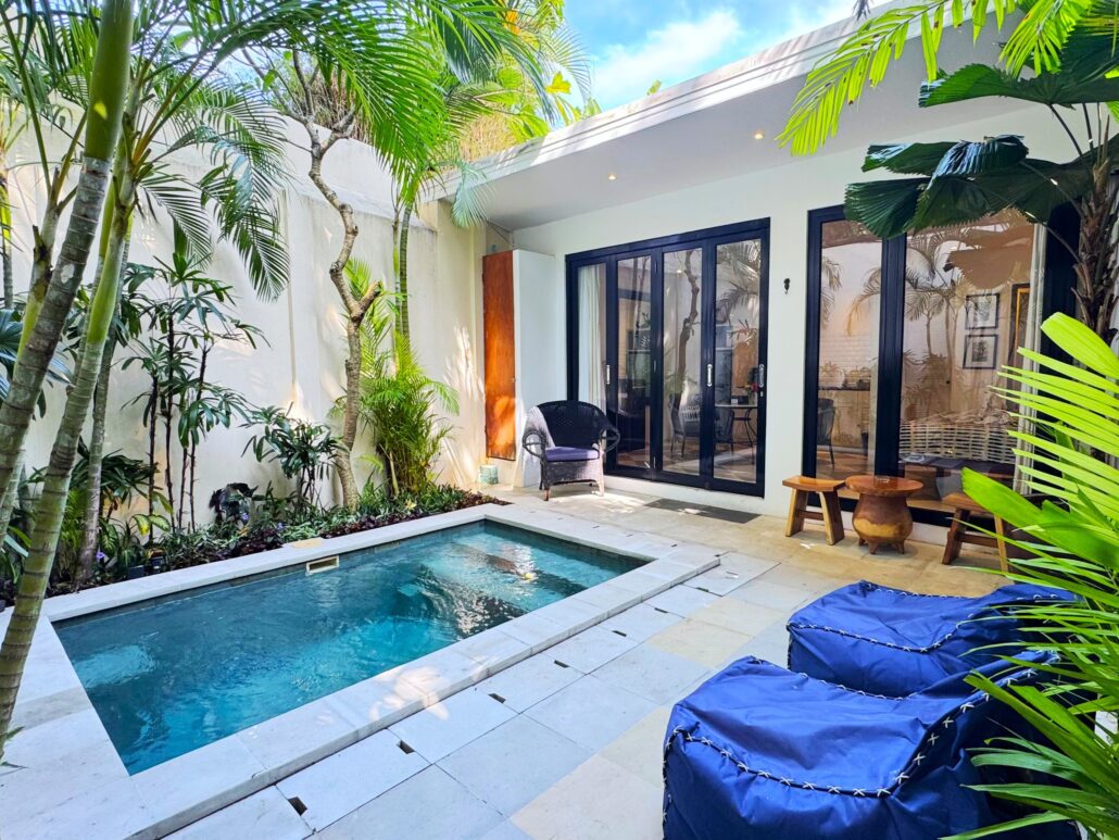 Serene private swimming pool with wooden decking at Villa Ibu Dua Seminyak