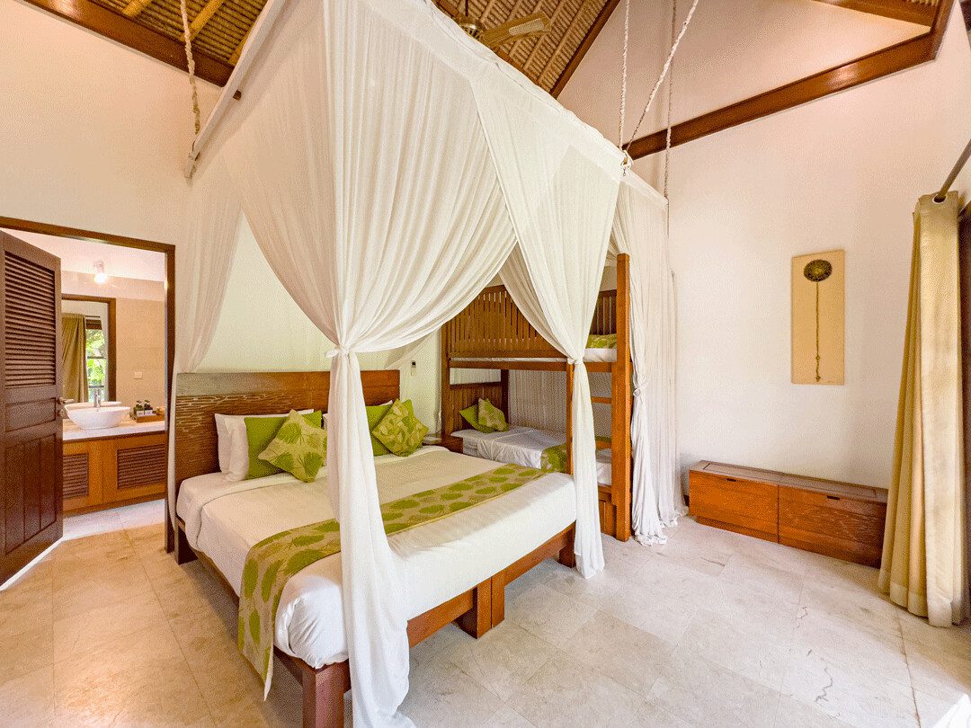 Large comfortable king-size bed with soft natural lighting in bedroom 4 at Villa Jaclan Seminyak by Villa Bugis, a highly recommended Seminyak villas choice.