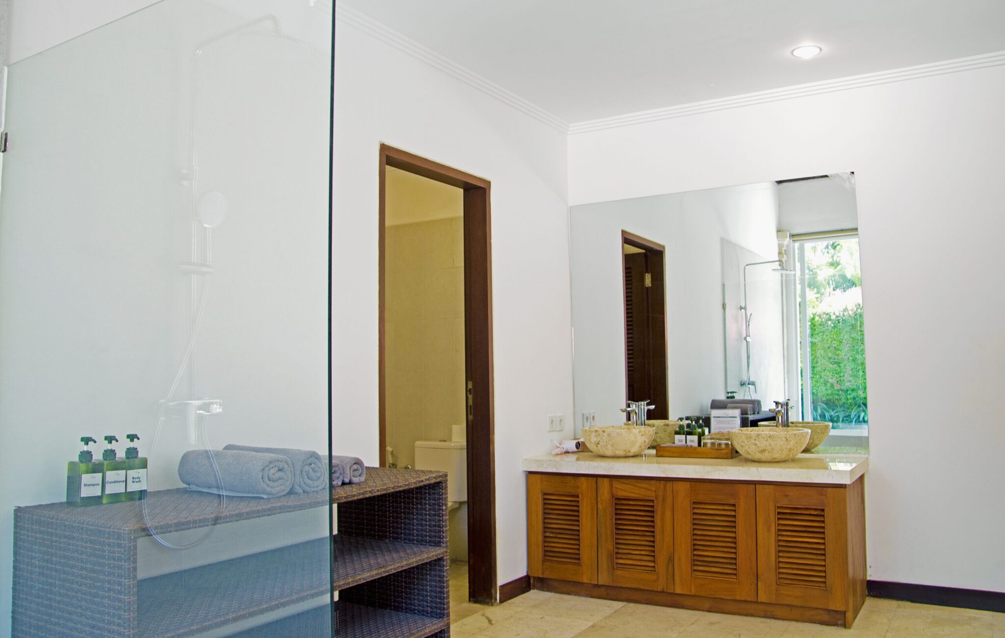 Clean modern vanity, stylish mirror, and premium amenities inside the master bathroom at Villa Jaclan Seminyak by Villa Bugis Seminyak villas.