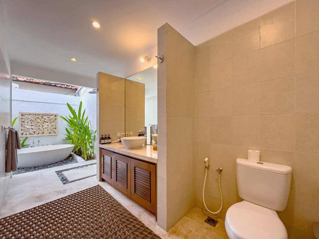 Well-lit vanity mirror and clean facilities inside the open-air bathroom of bedroom 3 at Villa Jaclan Seminyak by Villa Bugis Seminyak villas.
